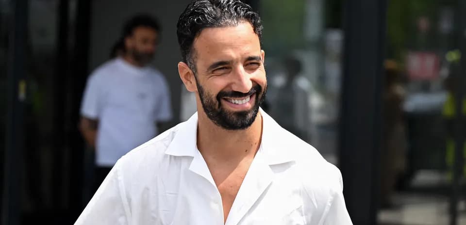 Smiling man in white shirt walking outdoors