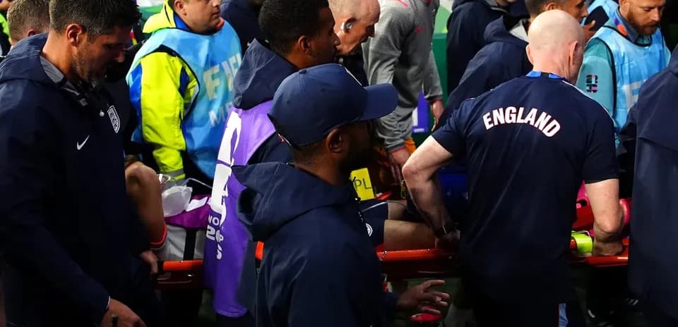 Medical staff attending to injured player on stretcher