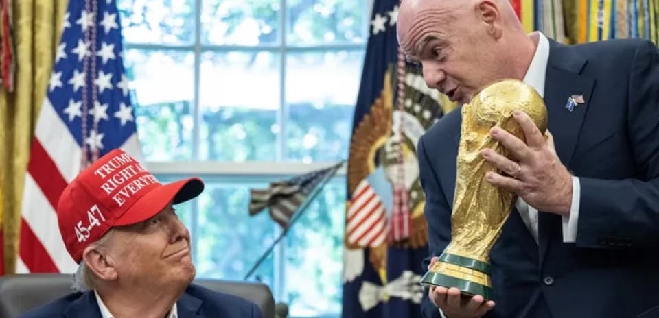 Person holding FIFA World Cup trophy in office