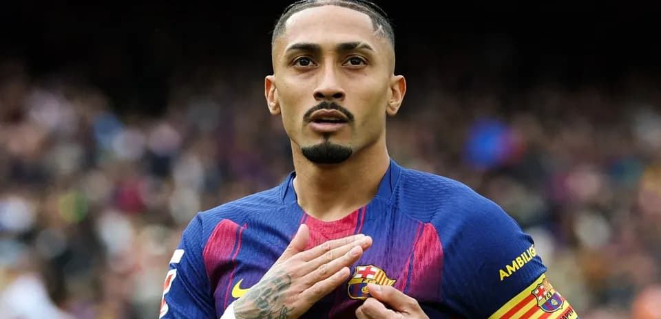 Player celebrating while touching FC Barcelona badge