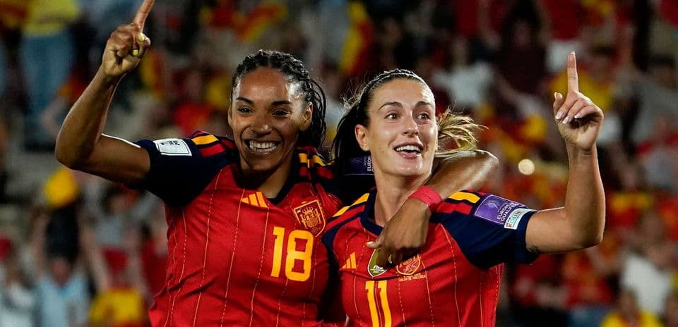 Two Spain players celebrating a goal together