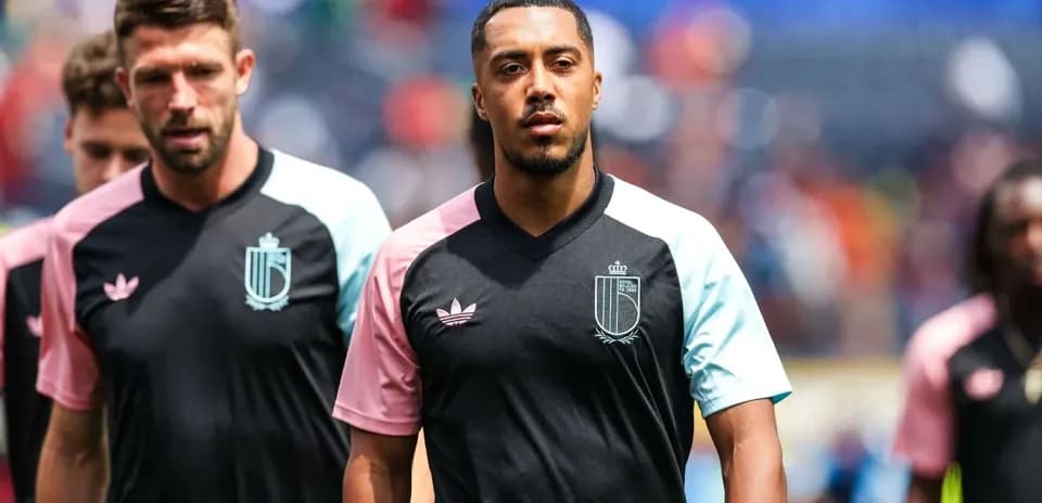 Players walking onto the field in warm-up jerseys