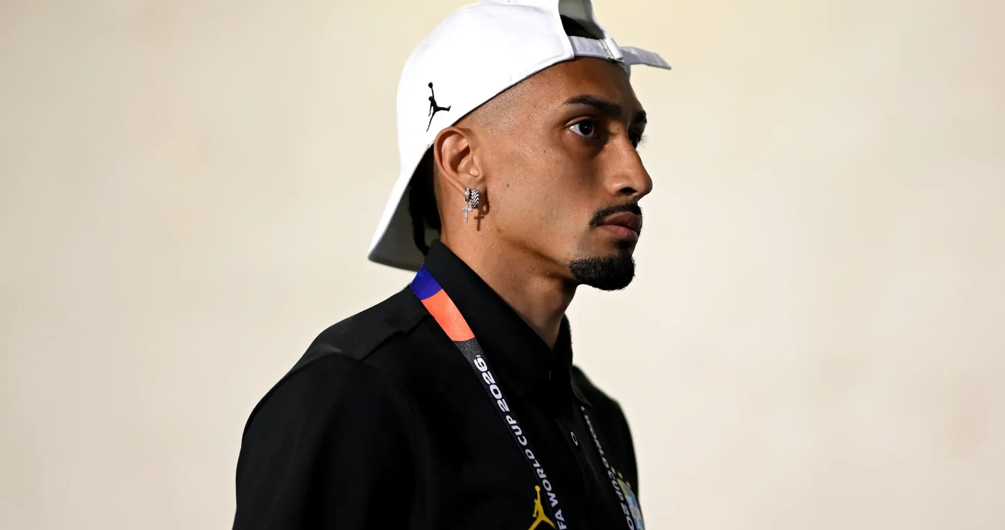 Individual wearing a cap and FIFA World Cup lanyard
