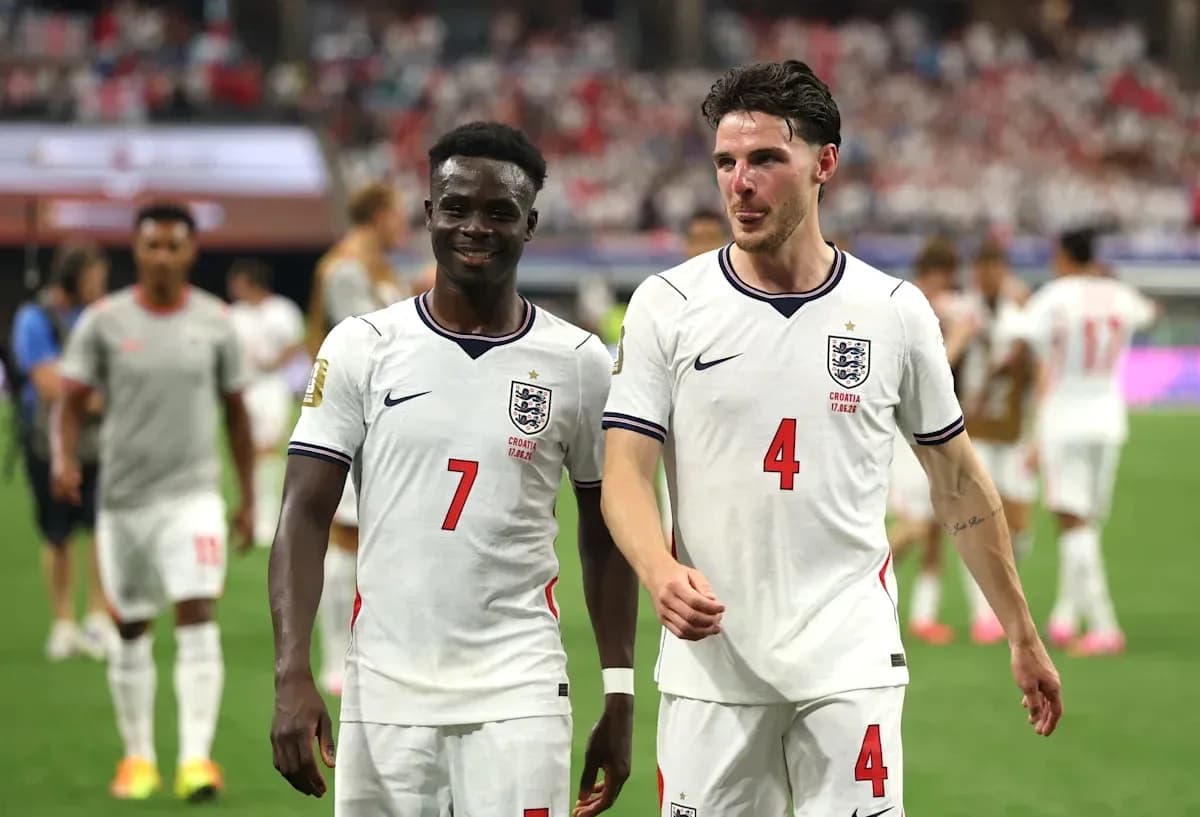 Two England players walking off the field after match