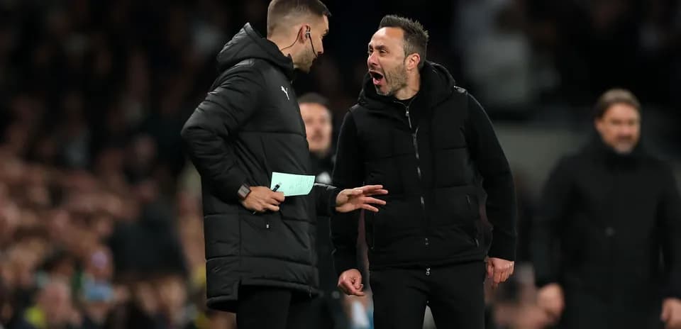 Two coaches discussing during a football match