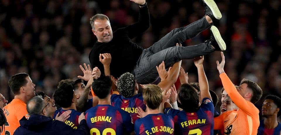 Team celebrating by lifting their coach after victory