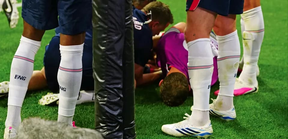 Players attending to injured teammate on field