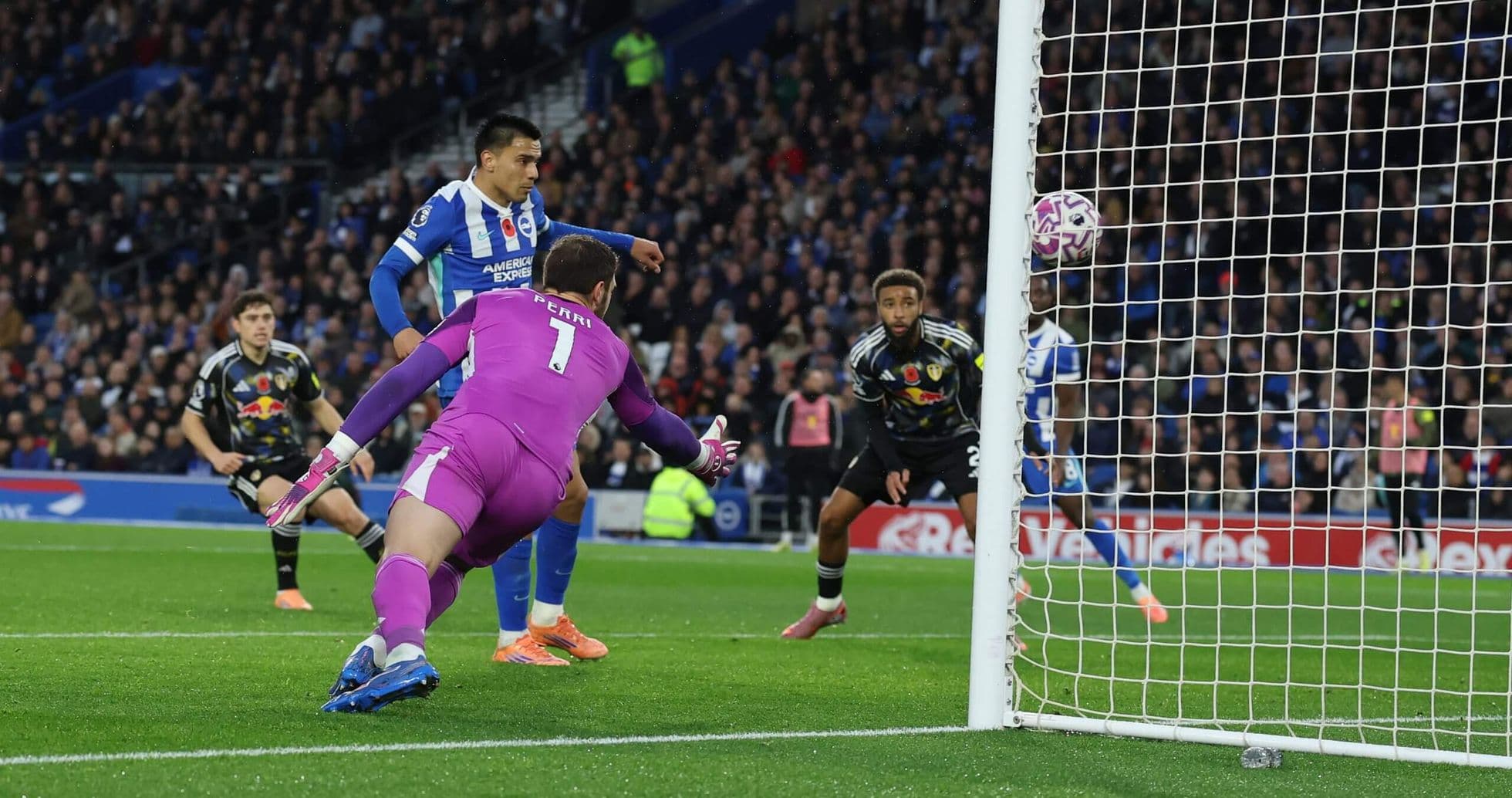 Brighton player scoring against Leeds goalkeeper