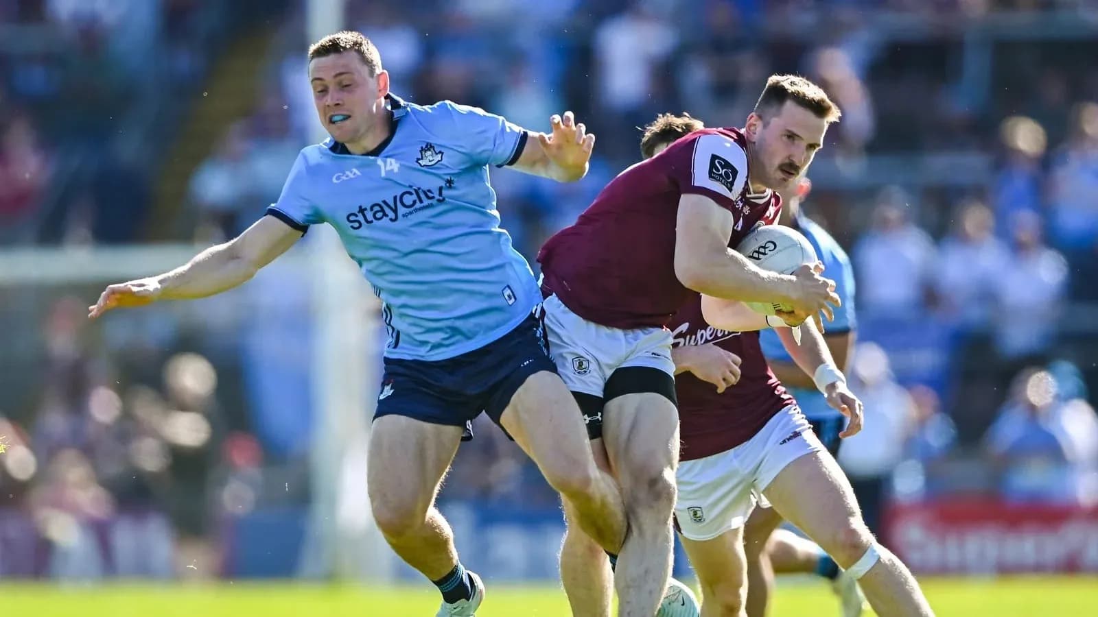 Player tackling opponent during rugby match action