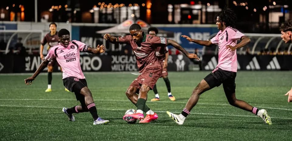 Players competing for the ball during match