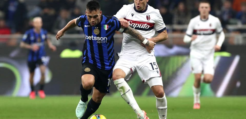 Inter player battling for the ball against Bologna