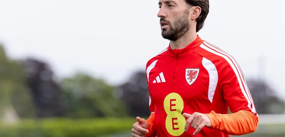 Player jogging in red training kit during practice
