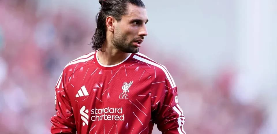 Goalkeeper in red Liverpool jersey on field