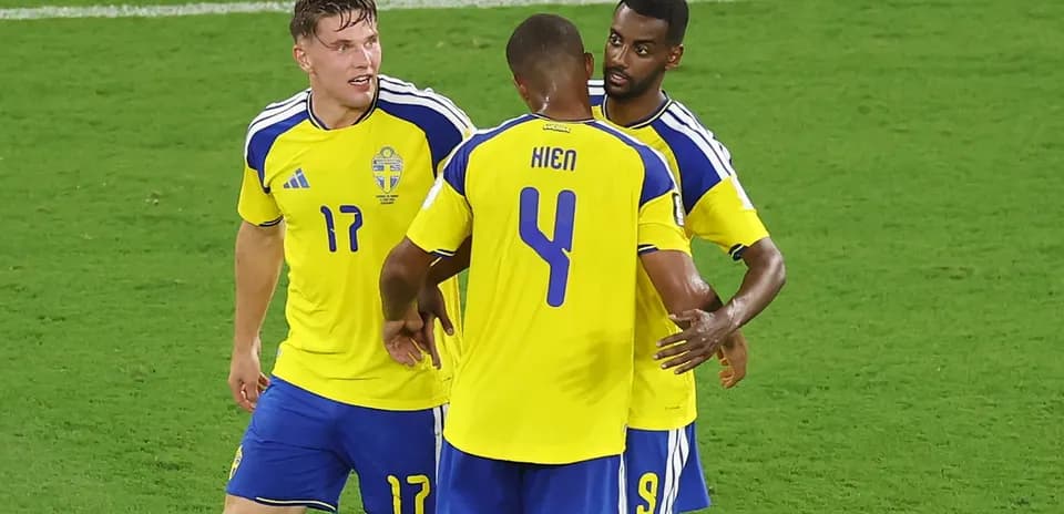 Sweden players celebrating on the field together