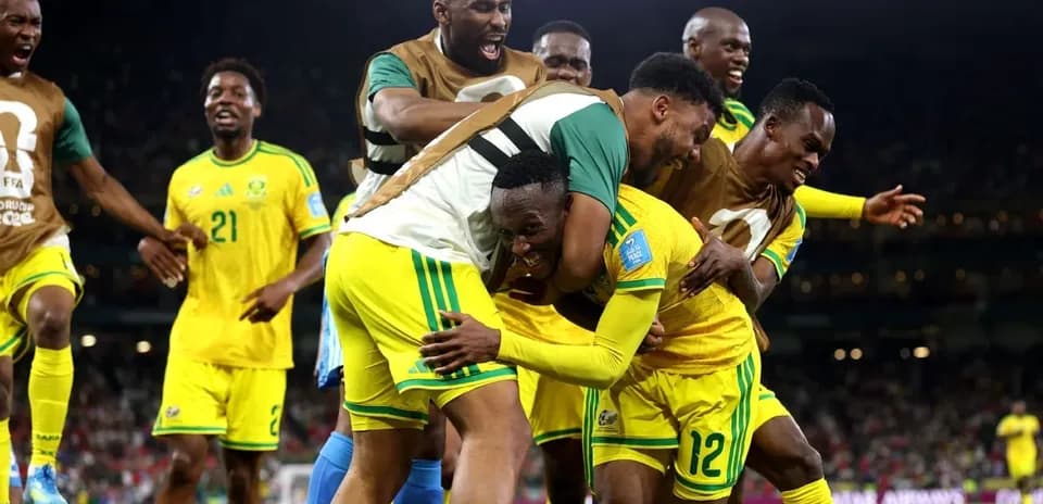 Players celebrating a goal during a football match