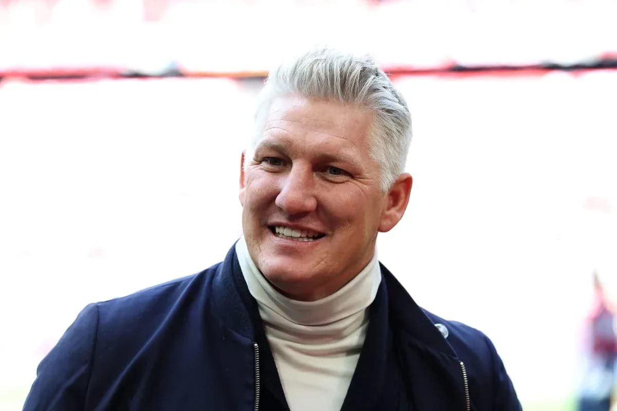 Smiling man in a navy jacket and turtleneck