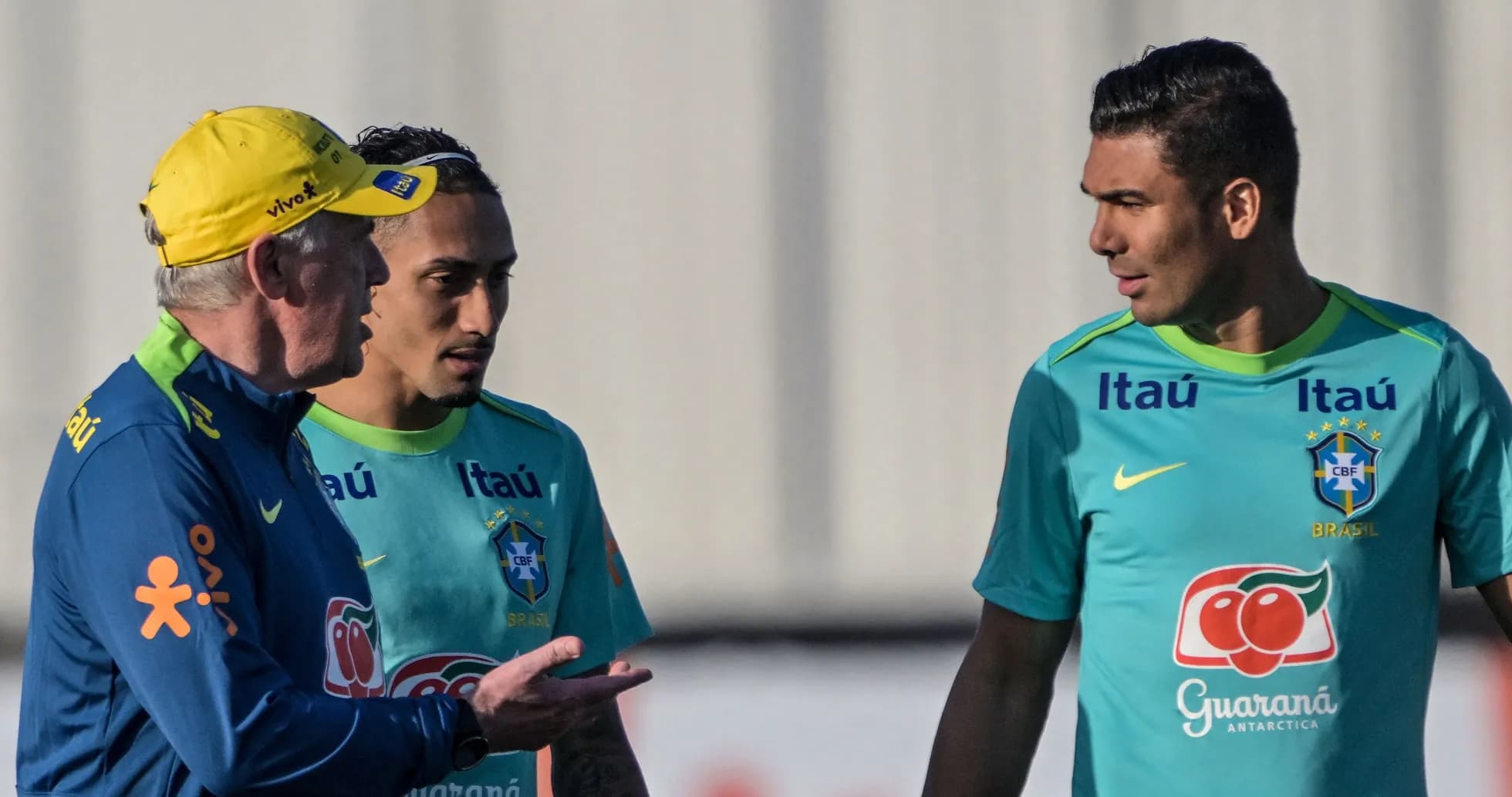 Coach discussing with two players during training session