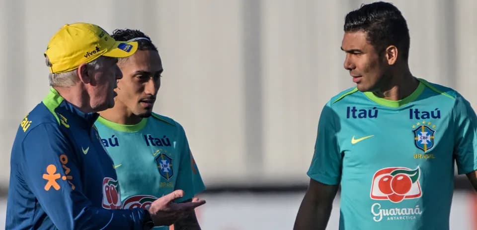 Coach discussing with two players during training session