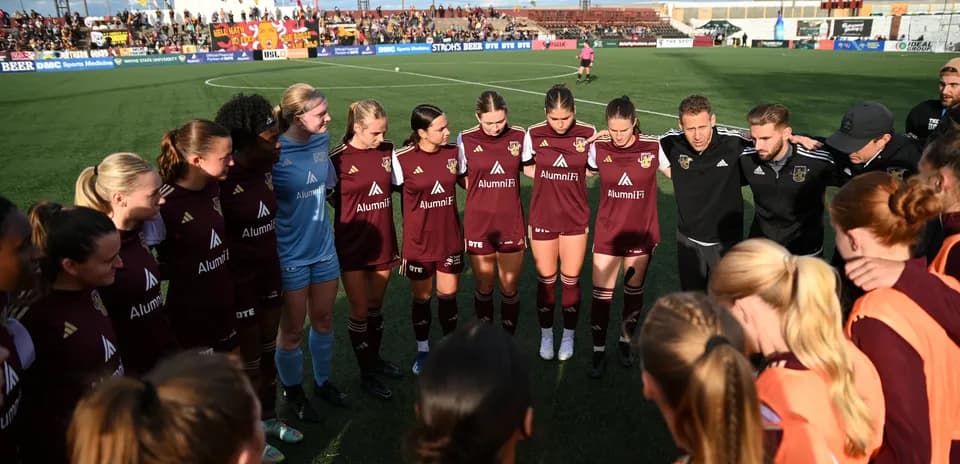 Detroit City women's team in pre-match huddle