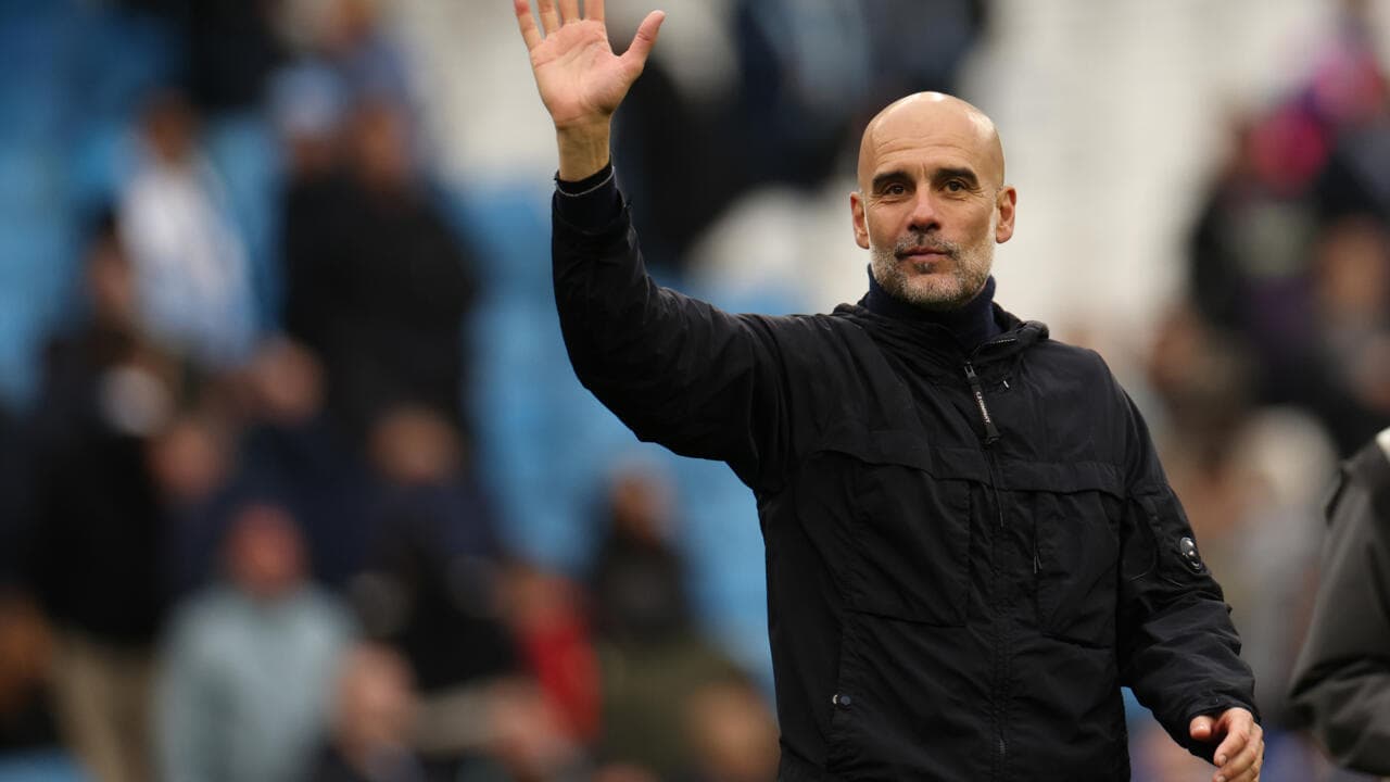 Manager waving to fans during match at stadium