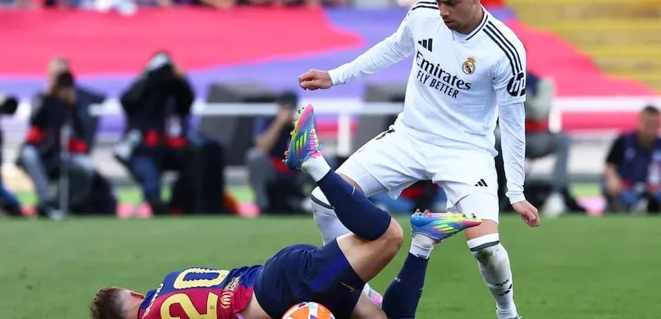 Barcelona player fouled by Real Madrid opponent