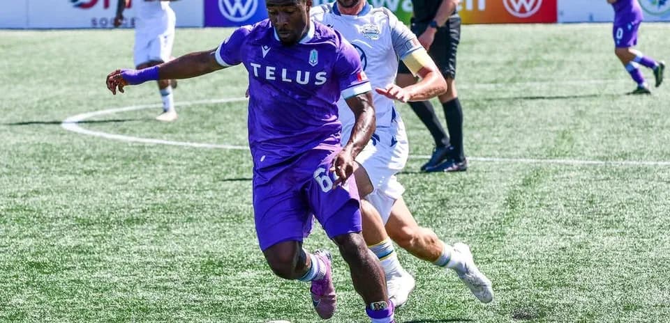 Pacific FC player dribbling past HFX Wanderers player