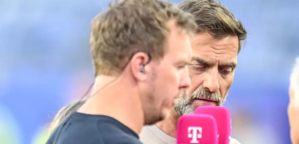 Two men speaking during a sports interview