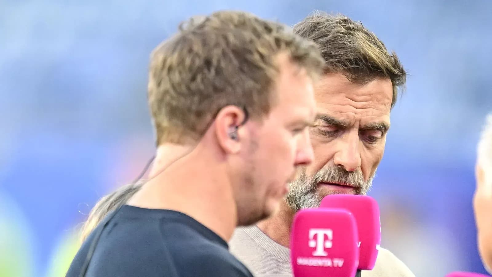 Two men speaking during a sports interview