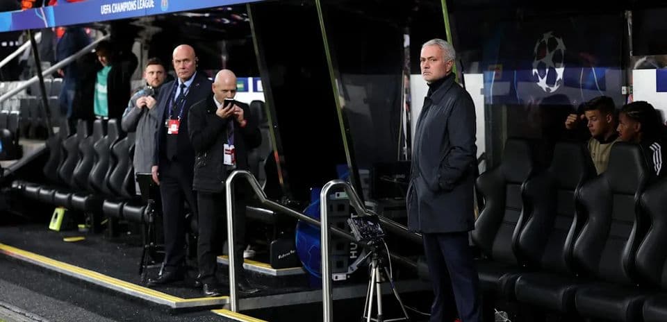Manager observing match from the dugout during UEFA Champions League