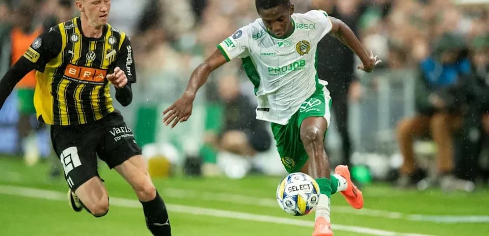 Player dribbling the ball while being chased