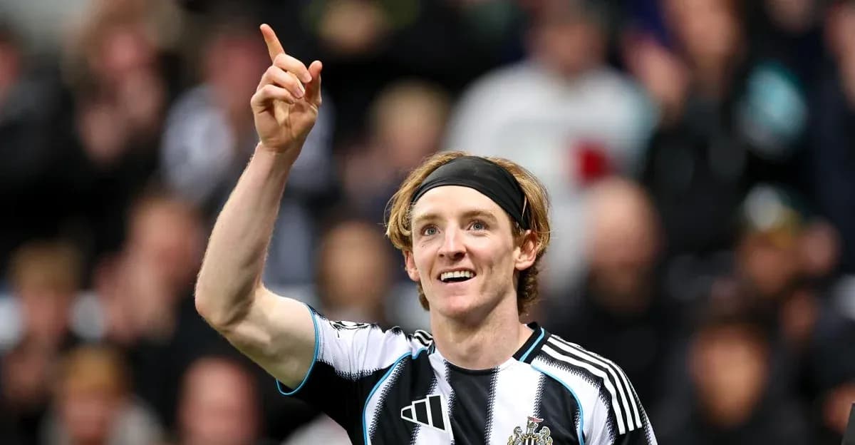 Player celebrating goal with raised finger in stadium