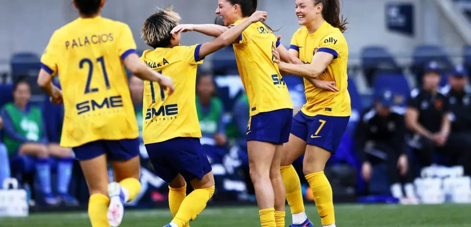 Players celebrating during NWSL match