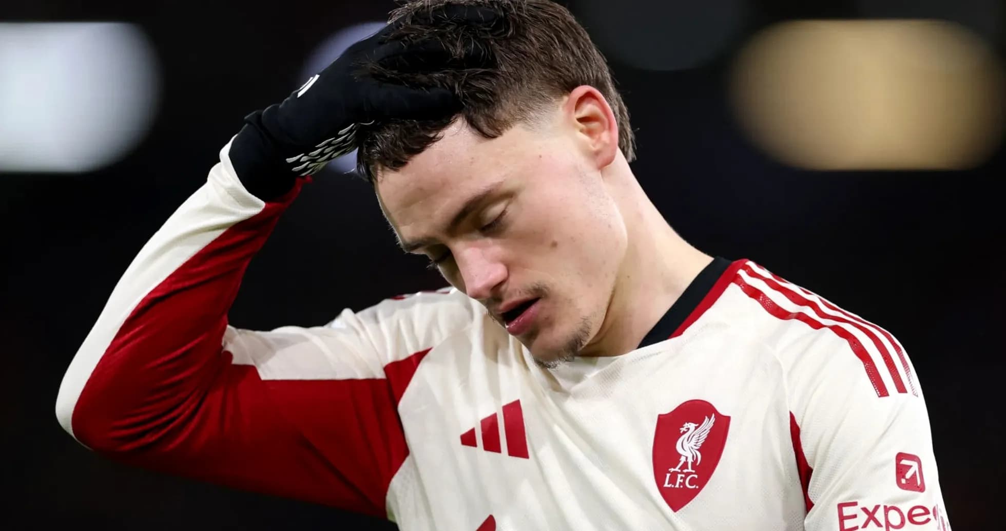 Player in Liverpool jersey looks down during match