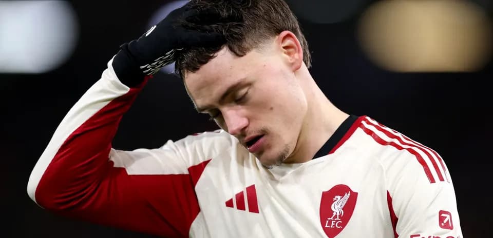 Player in Liverpool jersey looks down during match
