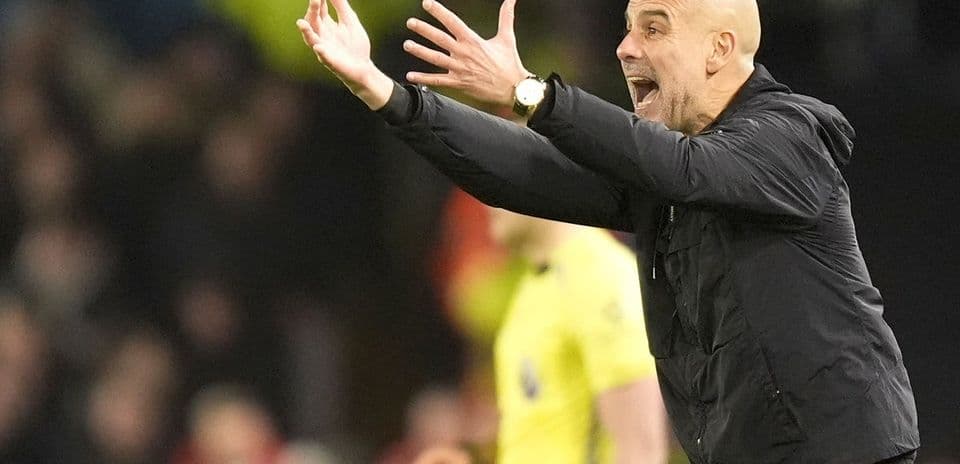 Manager gesturing during a match from the sidelines