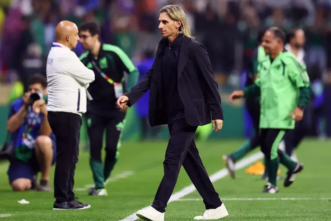 Coach walking on field during match with staff