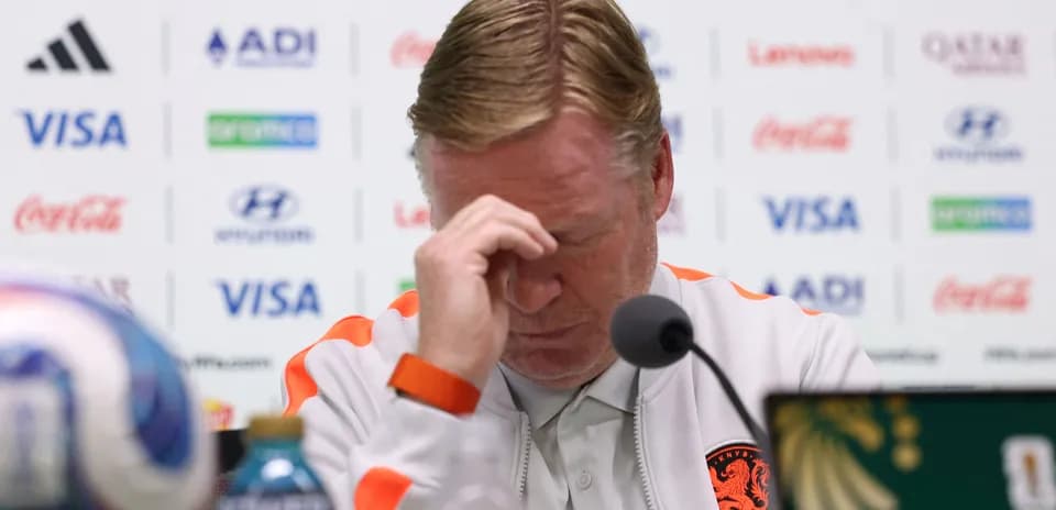 Manager at press conference with head in hands