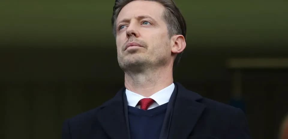 Man in suit observing from stadium stands