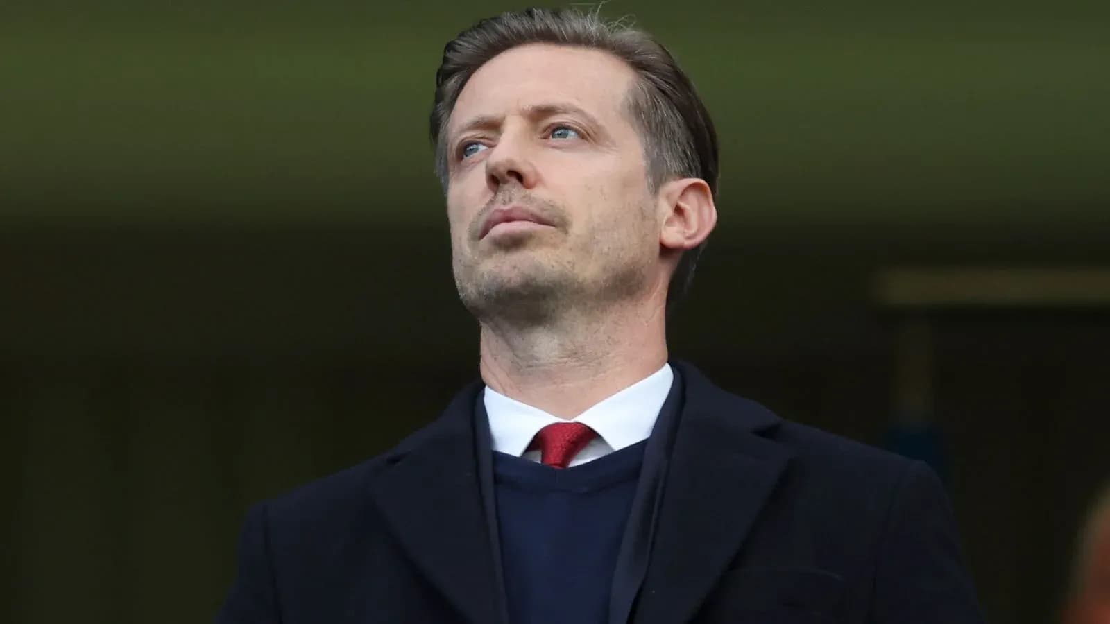 Man in suit observing from stadium stands