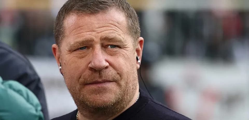 Person wearing earbuds, looking serious outdoors