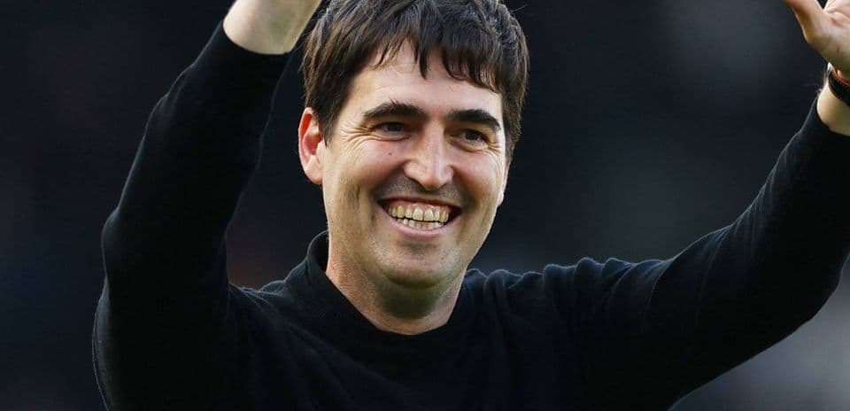 Man smiling and waving during a celebration
