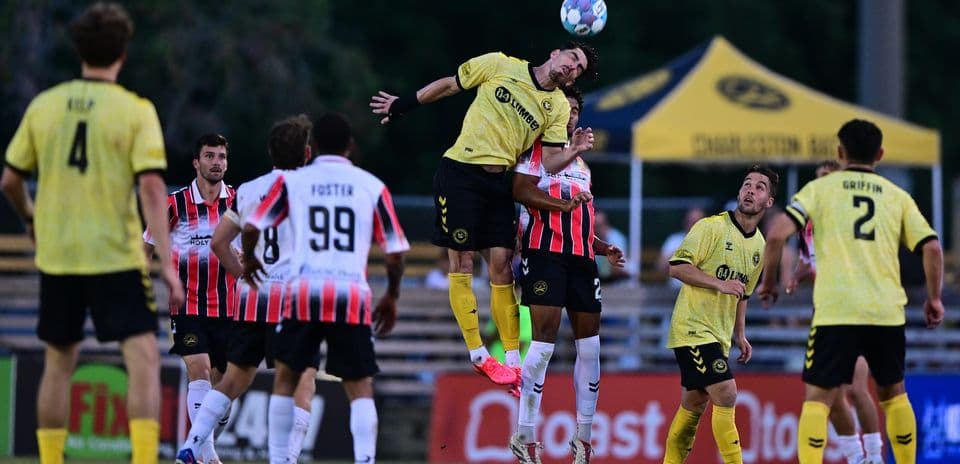 Player jumping for header during Charleston Battery match