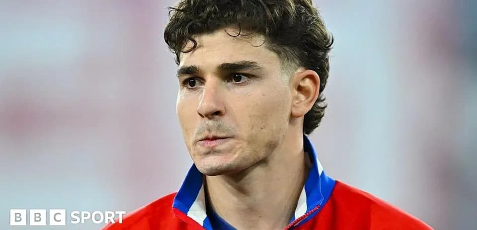 Player wearing a red jersey, looking serious