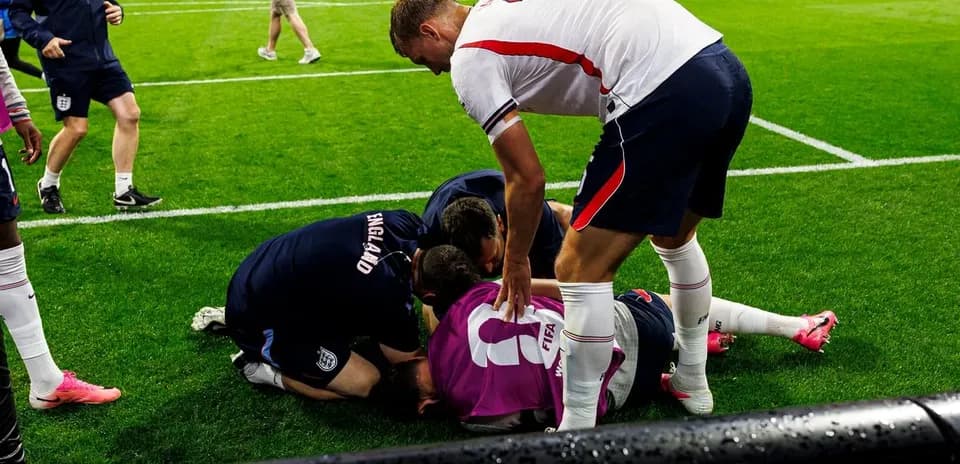 Players assisting injured teammate on the field