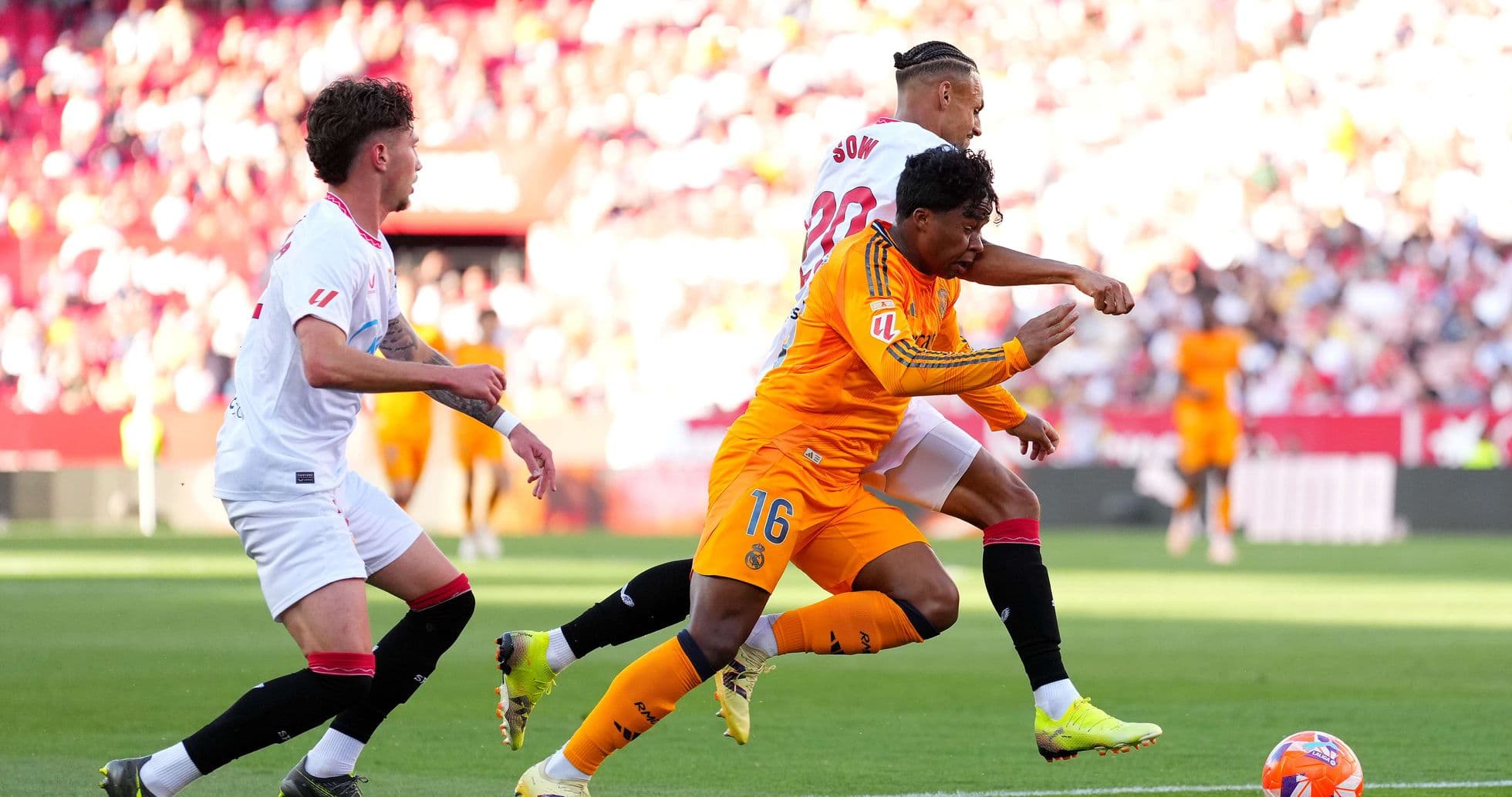 Sevilla and Real Madrid players in action