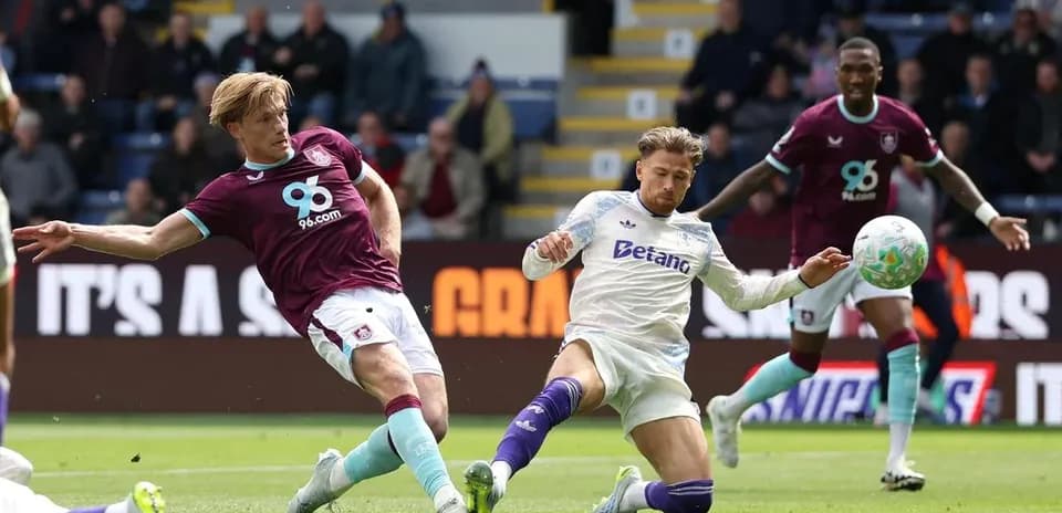 Player sliding tackle during Burnley vs Aston Villa match