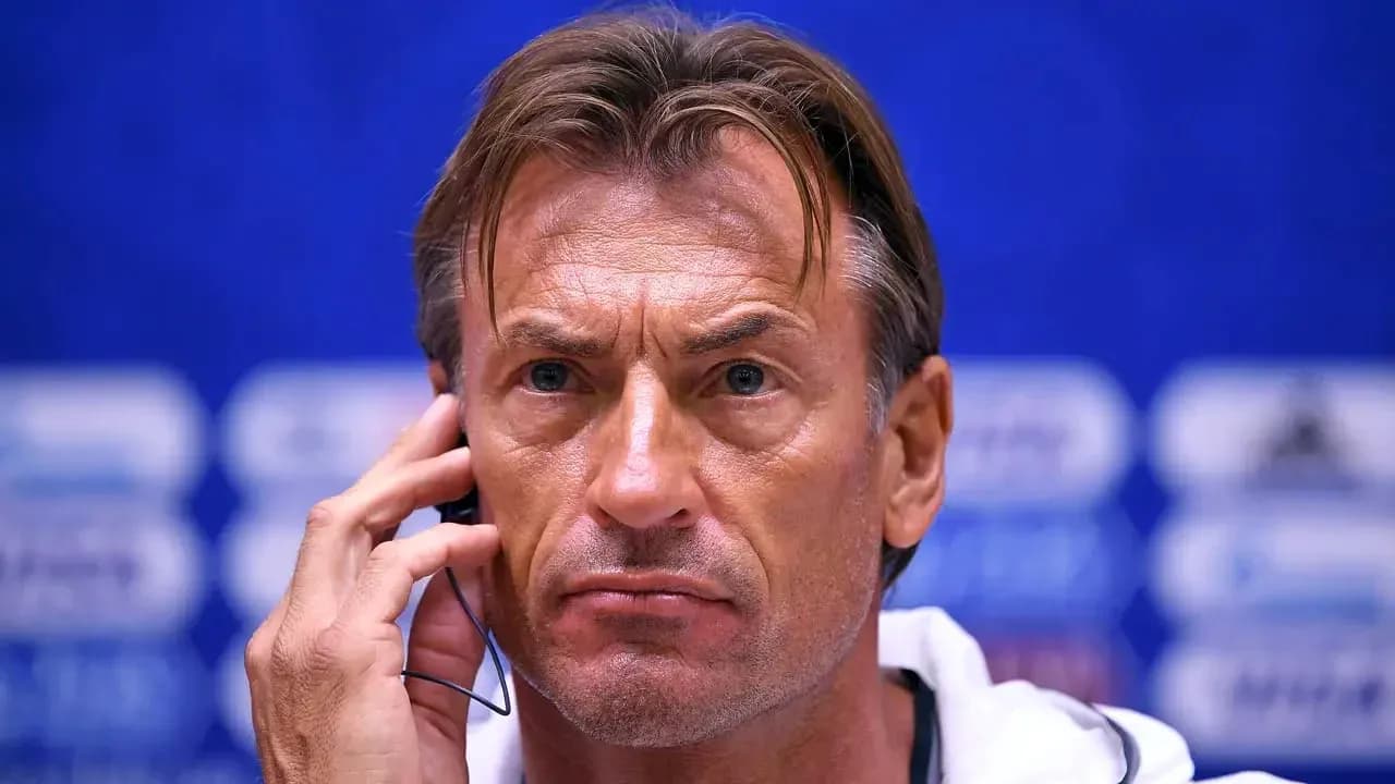 Coach speaking into headset during press conference