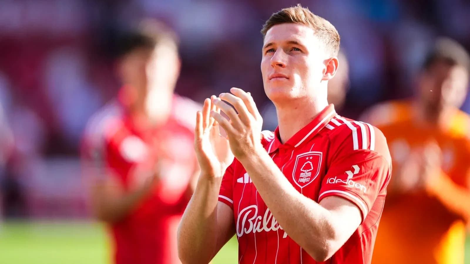 Player applauding fans in Nottingham Forest jersey