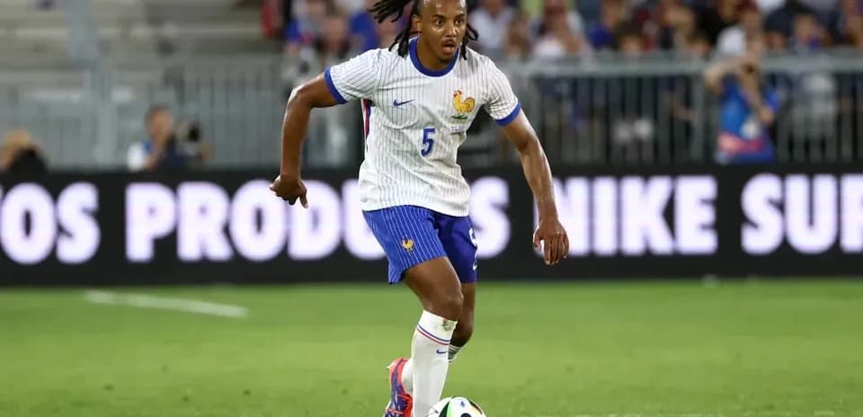 Player dribbling ball during football match