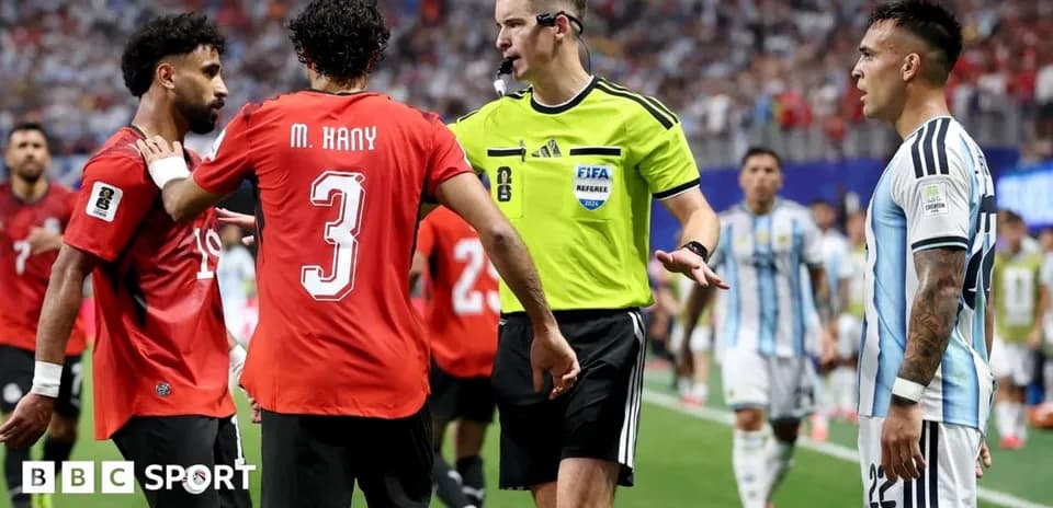 Players discussing with referee during intense match